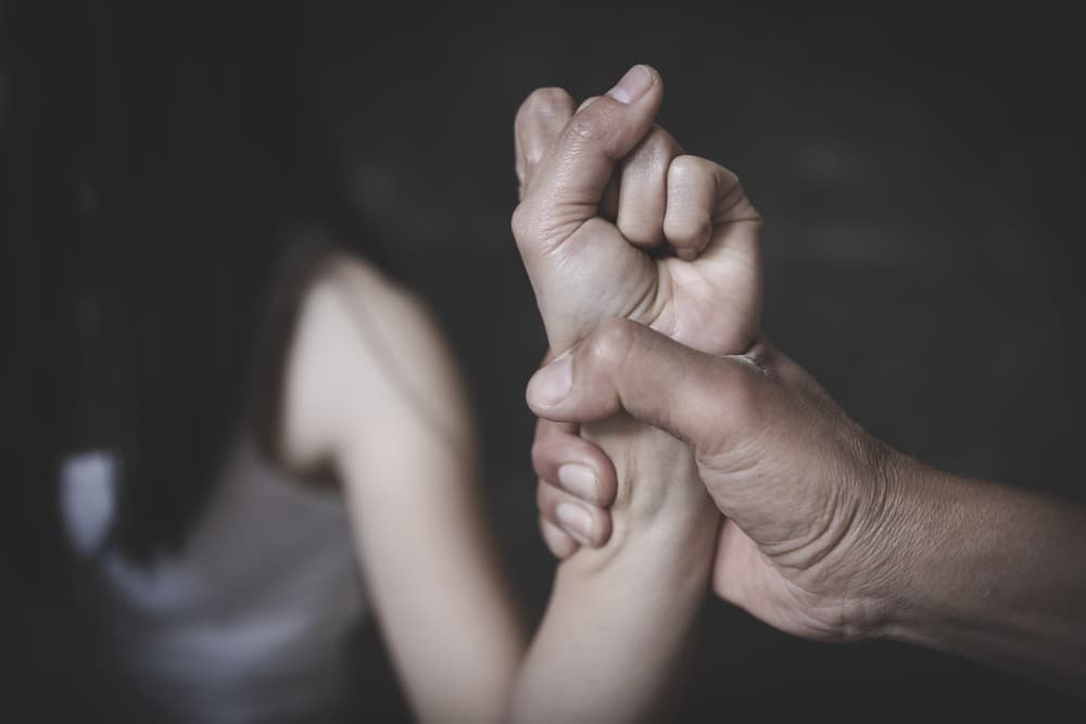 Image of a woman showing signs of distress, representing a victim of domestic violence and abuse.