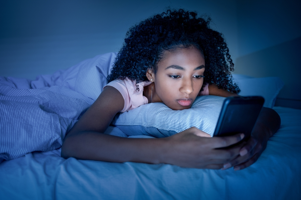 teen in foster care system depressed over abuse reads on her phone